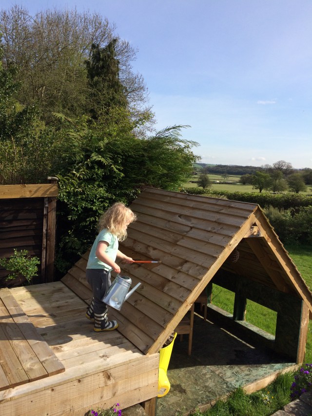 Rosie painting her playhouse yesterday